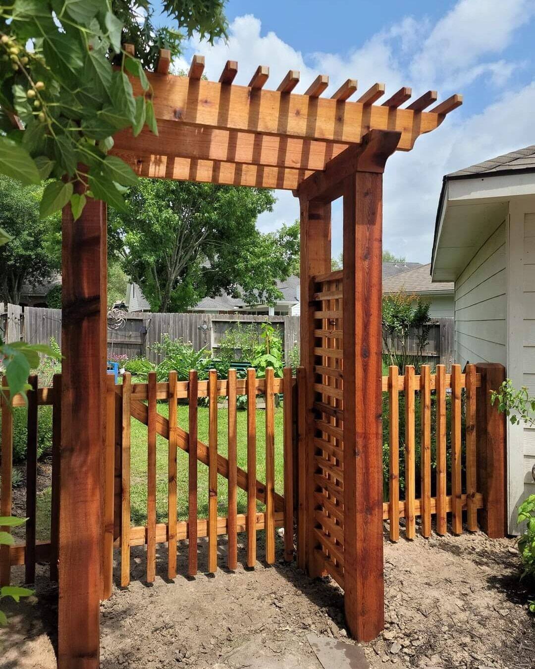 Cedar arbor with pergola top and lattice panel over garden gate