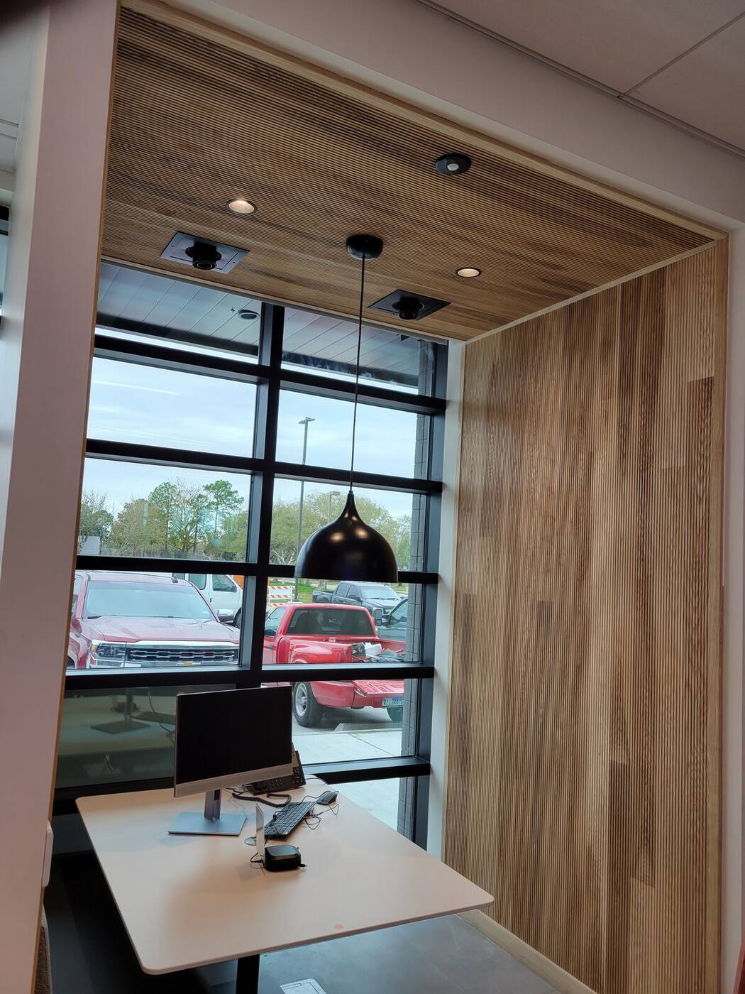 Work nook with wood slat wall and wood ceiling panels