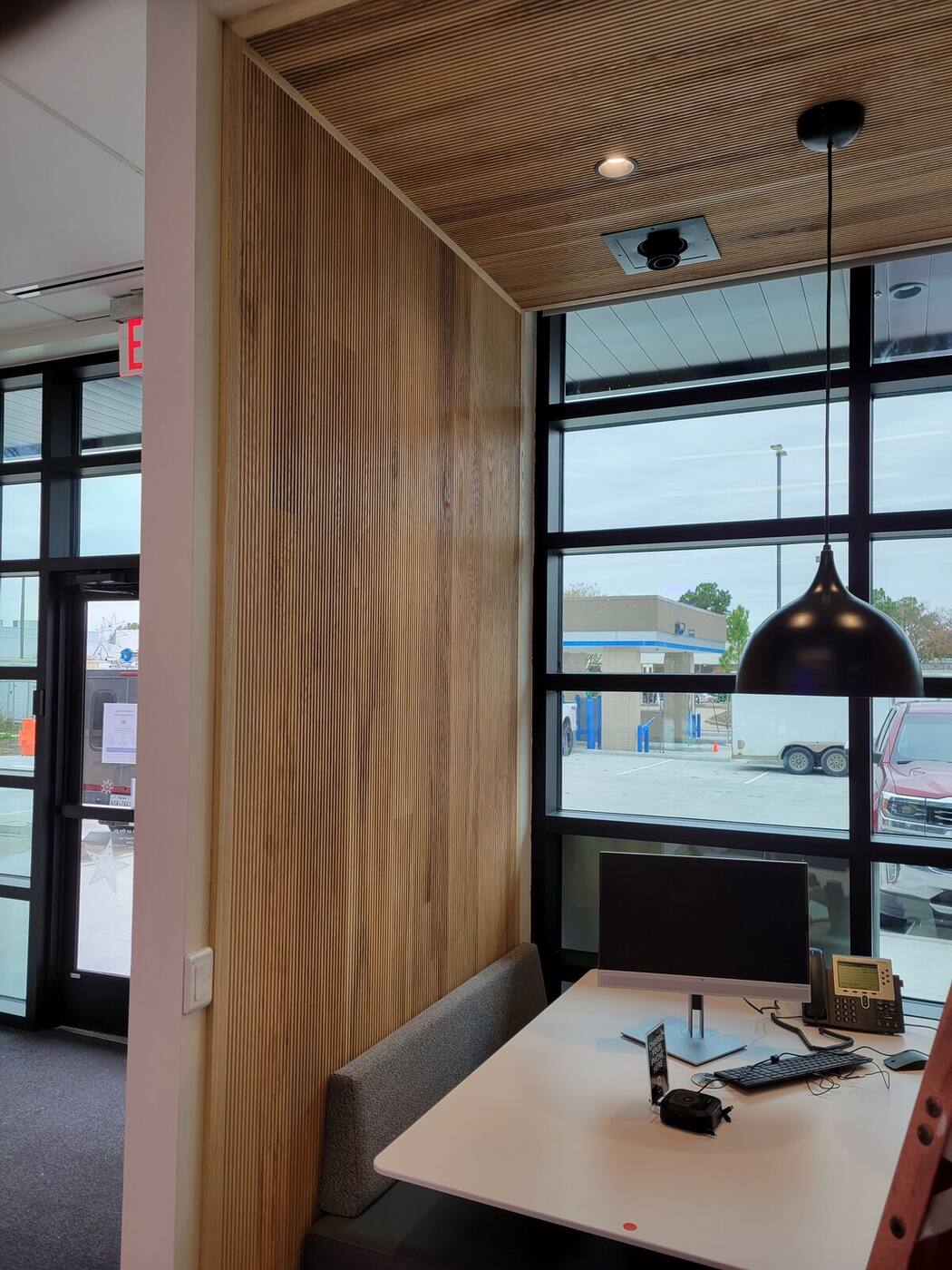 Wood slat wall detail beside window booth in bank branch
