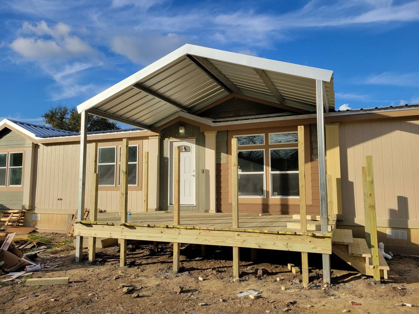 Same porch during construction, deck framed with no railing