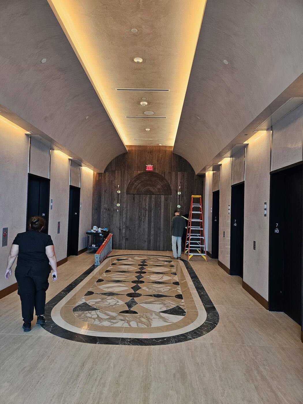 Elevator lobby with full-height wood feature wall