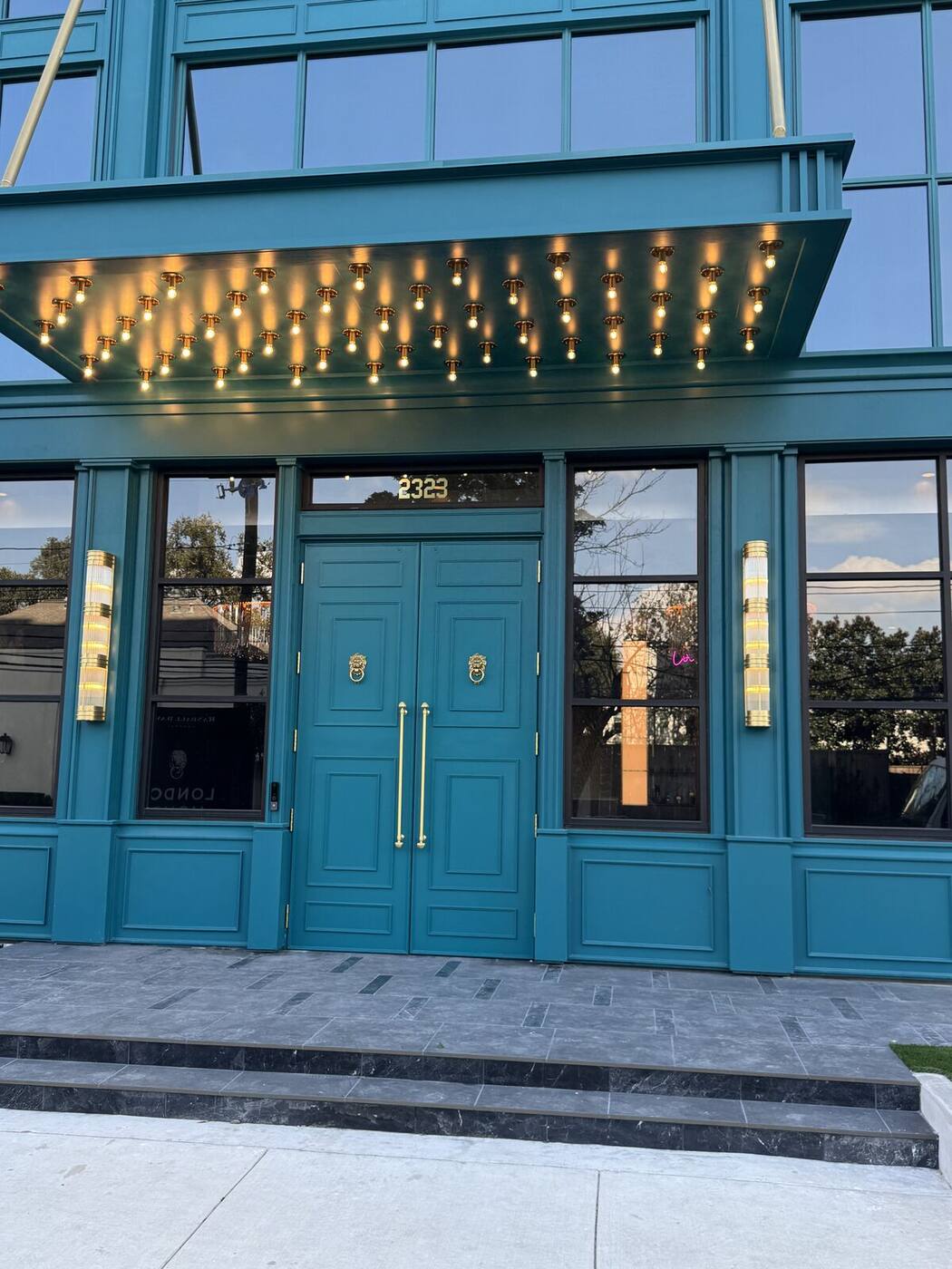 Hotel entrance with paneled doors and millwork surround