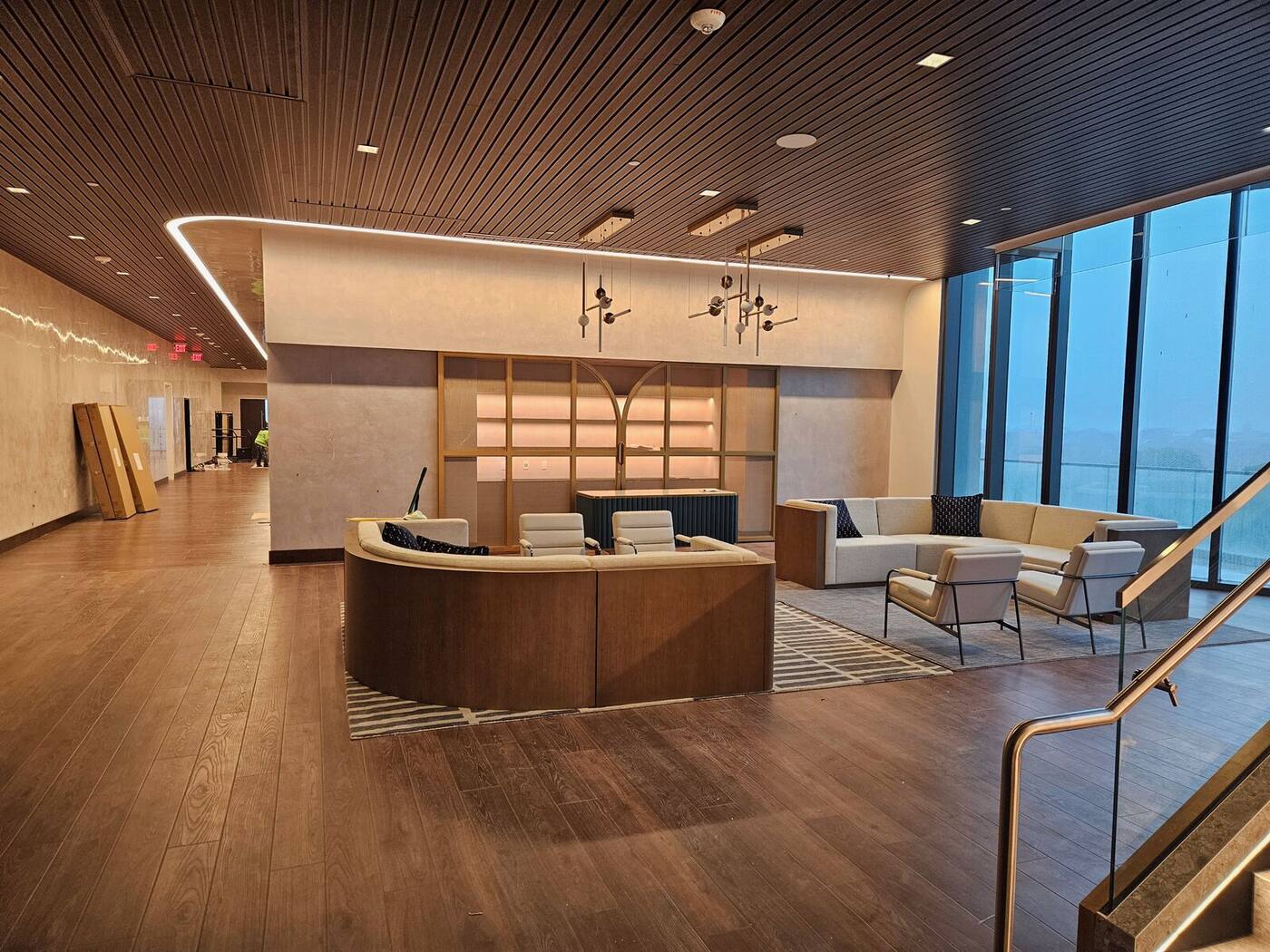 Hotel lobby lounge with wood wall paneling and brass shelving
