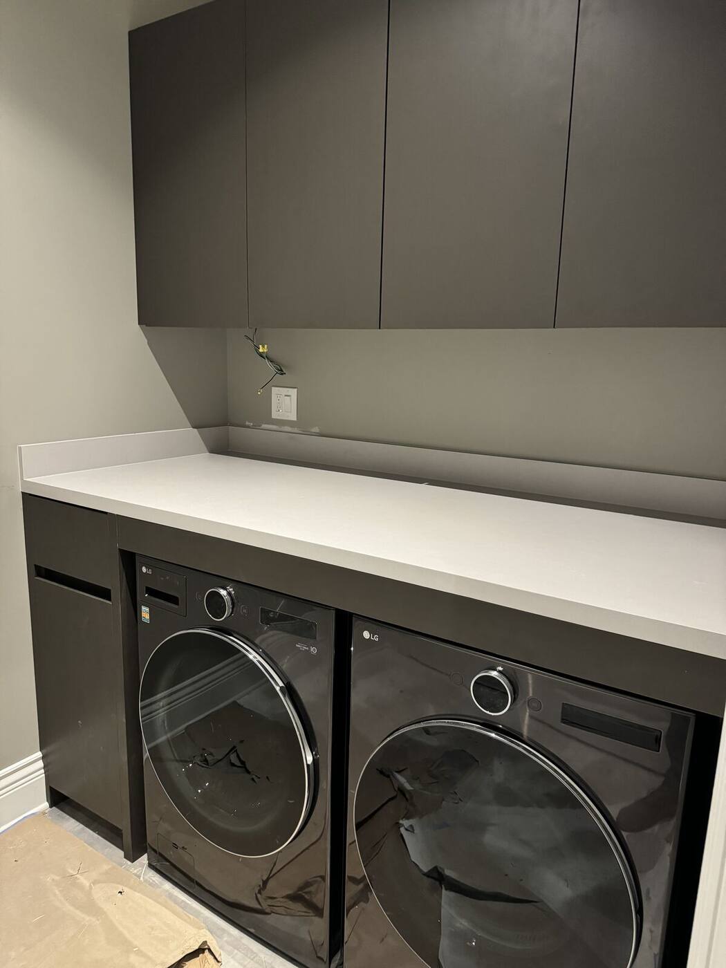 Laundry room cabinets over washer and dryer with counter