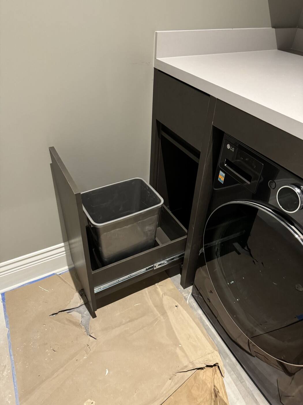 Pull-out hamper drawer beside washing machine