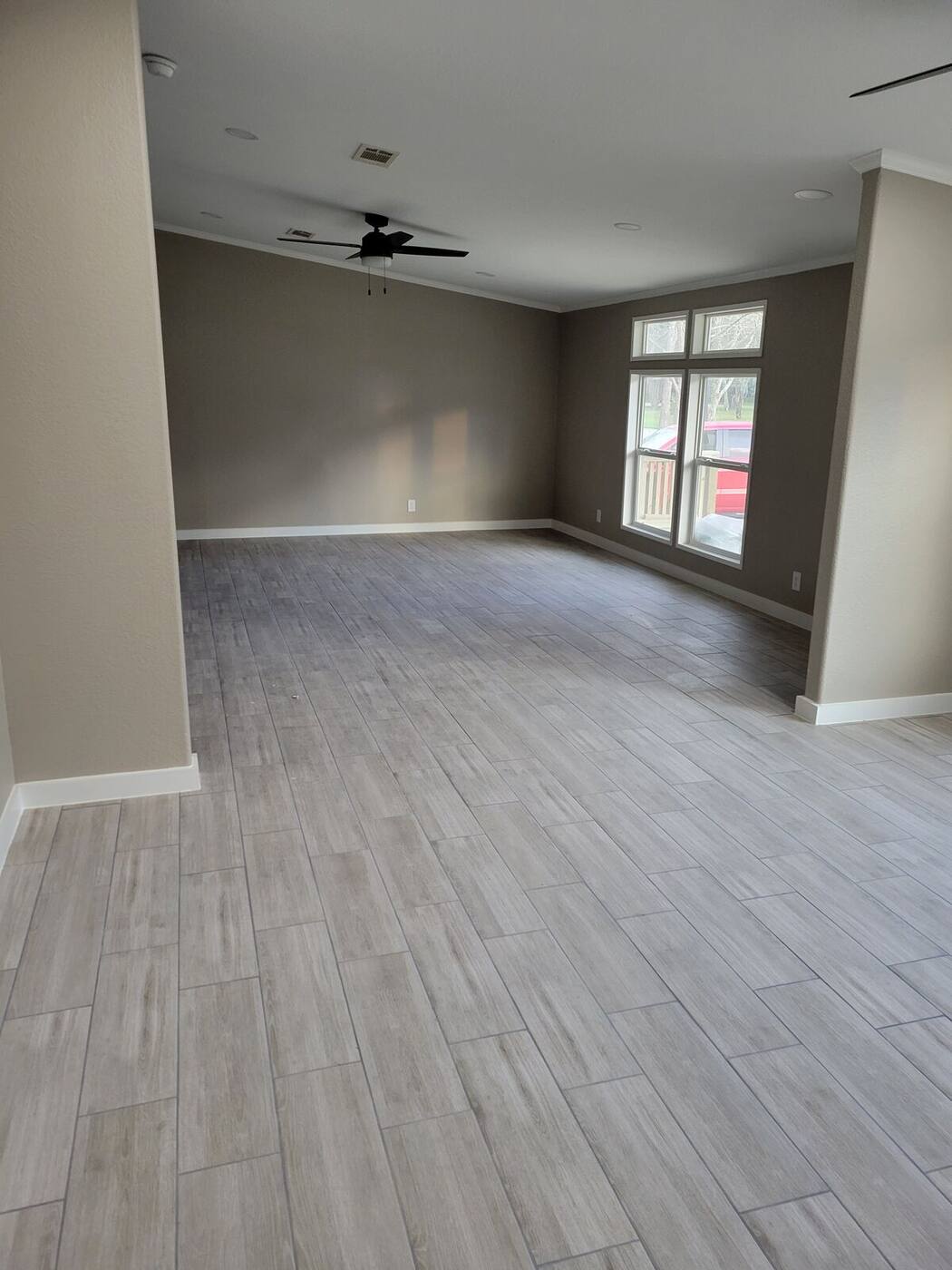 New plank flooring with fresh trim in empty living room